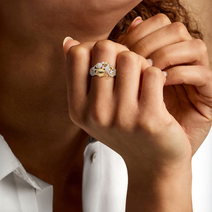Sea life diamond ring on finger, two-tone sterling silver with gold shell and starfish motifs