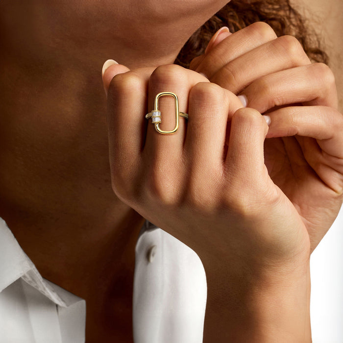 Gold diamond-accent carabiner-link ring on hand, open oval frame and baguette set
