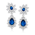 Sterling silver drop earrings with blue teardrop stones and CZ snowflake clusters