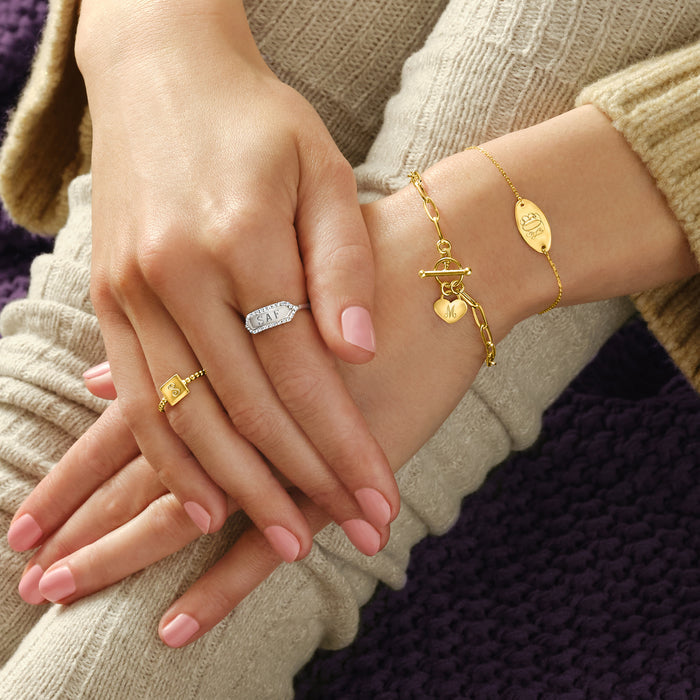 Sterling silver diamond personalized ring on hand with oval engraved initials