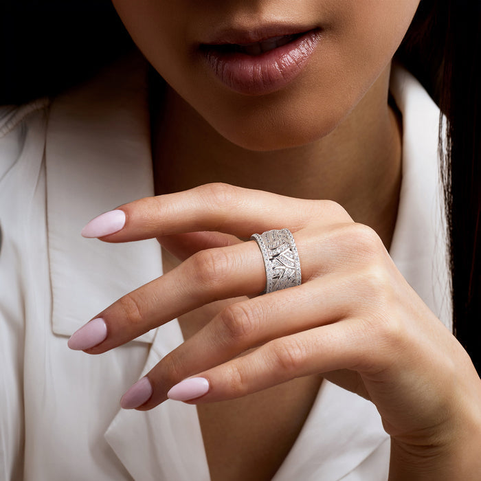 Sterling silver CZ eternity ring on finger, textured swirl band with stones
