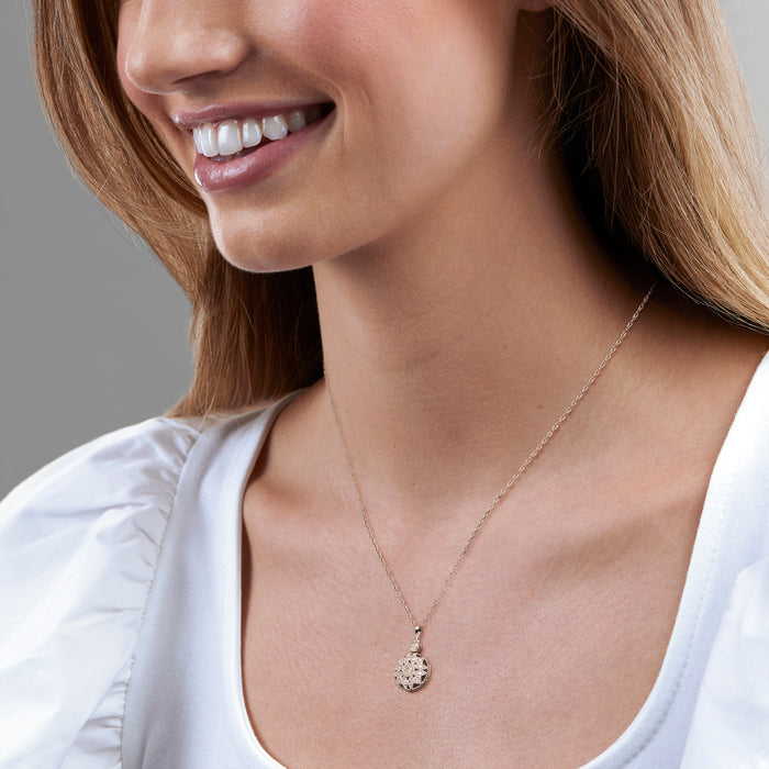Sterling silver diamond pendant necklace worn with small round pendant at neckline