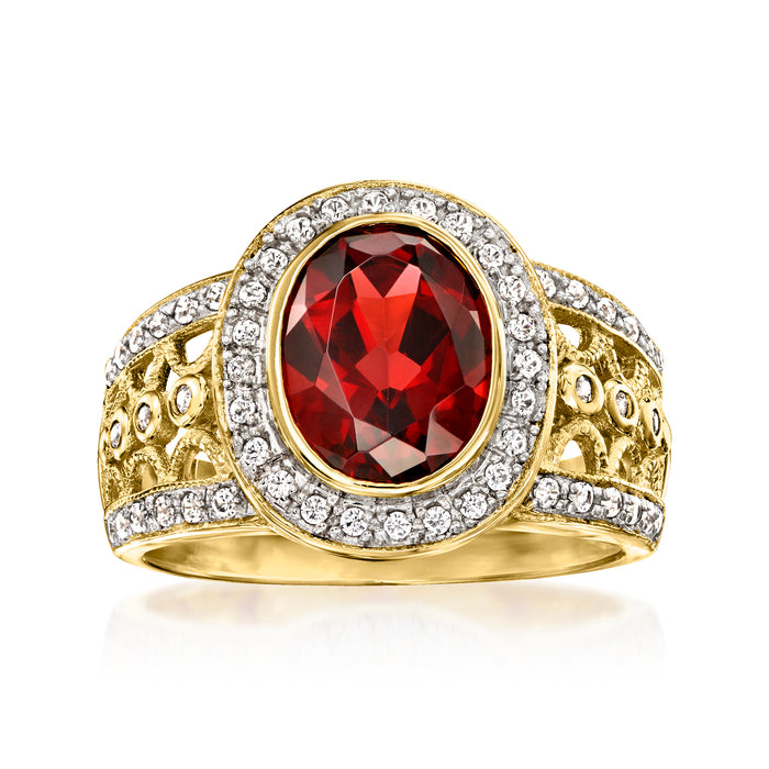 Oval red garnet ring with white zircon halo and filigree in gold over sterling
