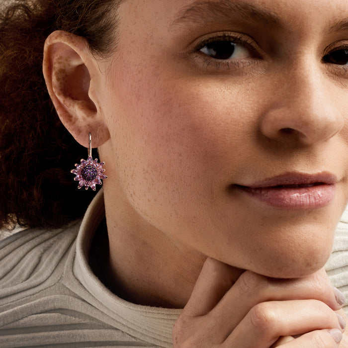 Amethyst flower drop earrings worn on ear, rose-gold leverback with purple petal stones