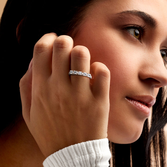 Sterling silver band ring with five oval blue stones and small round diamond accents