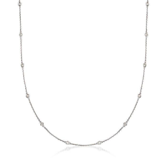 Sterling silver diamond station necklace with bezel-set round stones along a thin chain.