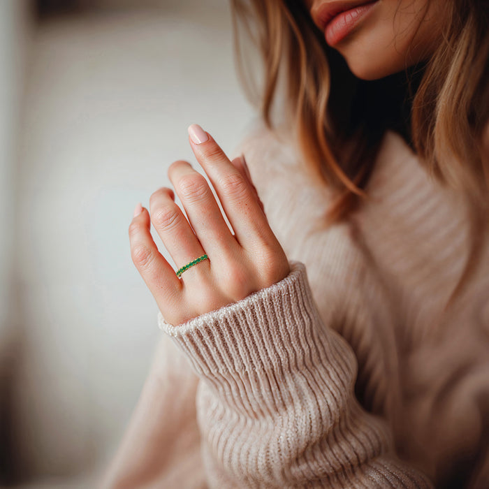 Emerald ring with green round stones on finger, 18kt gold over sterling band