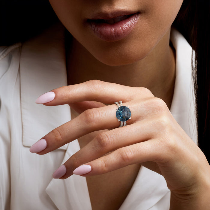 Sterling silver ring with oval London blue topaz on finger, roped setting