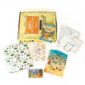 A paperback edition of The Firefly Summer stands on a yellow OUABC box. In front of the box are four themed wrapped gifts labeled with page numbers. Each gift has summer-themed wrapping paper.