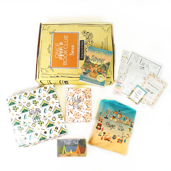 A paperback edition of The Firefly Summer stands on a yellow OUABC box. In front of the box are four themed wrapped gifts labeled with page numbers. Each gift has summer-themed wrapping paper.