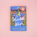 Book cover of 'A Winter Wish' by Emily Stone on a pink background