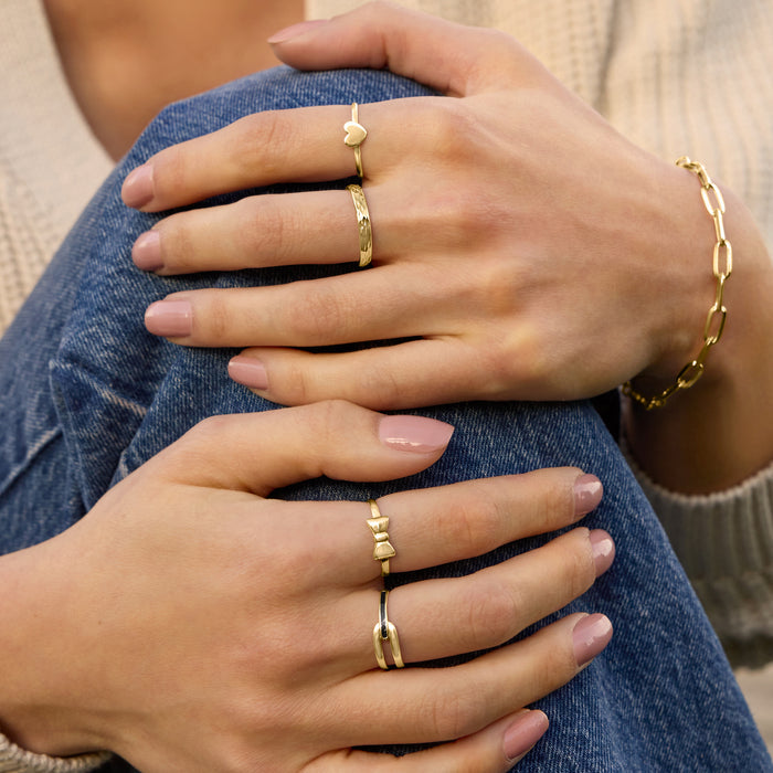 Interlocking black enamel ring in 10kt yellow gold worn on finger
