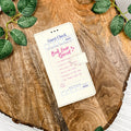 Phone case with a Book Lover Special restaurant check design and quirky list of what's included in pink writing.