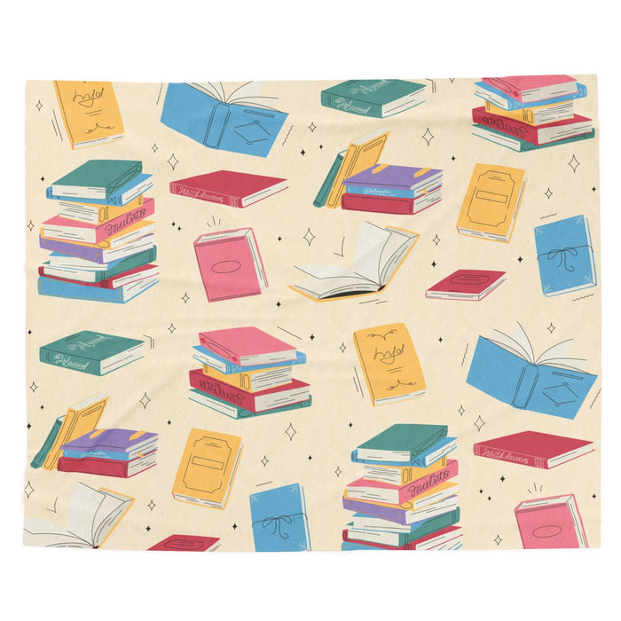 A digital rendering of a blanket featuring colorful books on a creamy butter yellow background