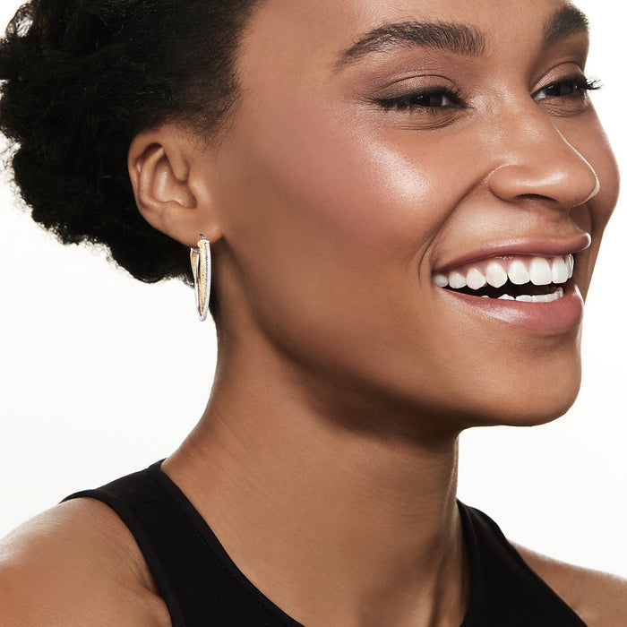 Charles Garnier two-tone crisscross mesh hoop earrings on ear