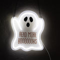 An LED sign in the shape of a ghost that says Read More Booooooks in orange text on the front. The sign hangs from a metal chain.