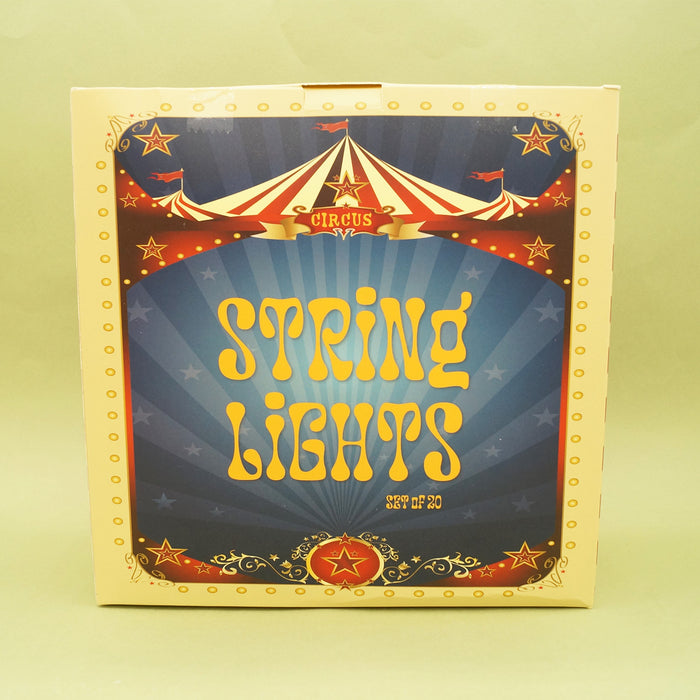 Box of string lights with circus-themed design on a yellow background