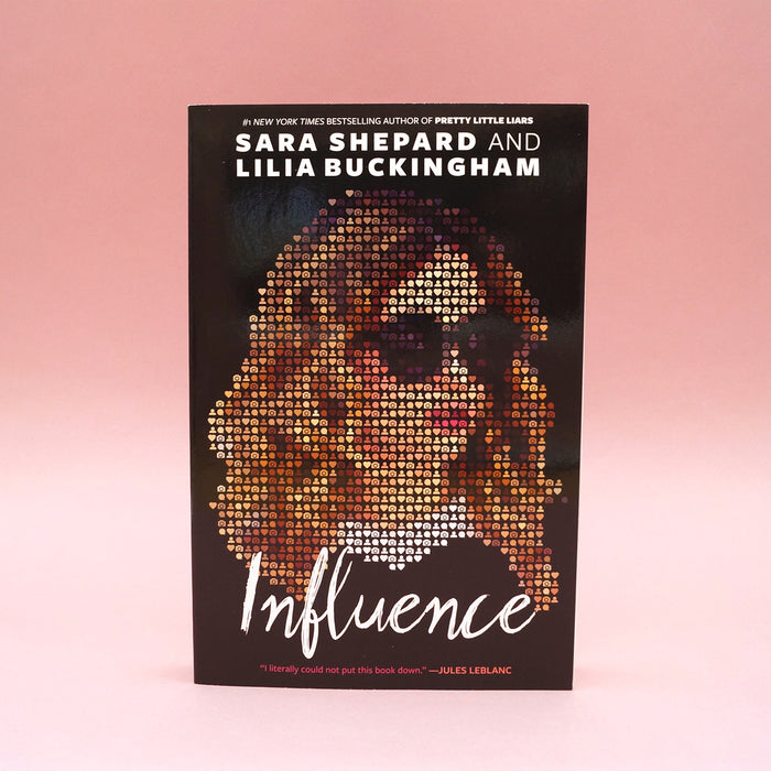 A paperback copy of Influence by Sara Shepard and Lilia Buckingham on a pink background.