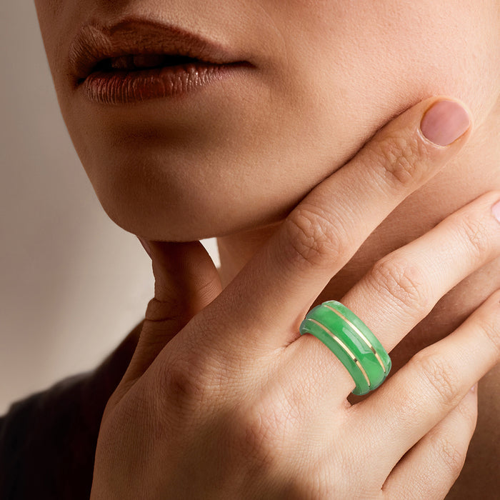 Green jade-style ring on hand with 14kt yellow gold inlay stripes