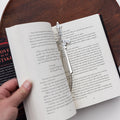 A silver metal dagger bookmark.