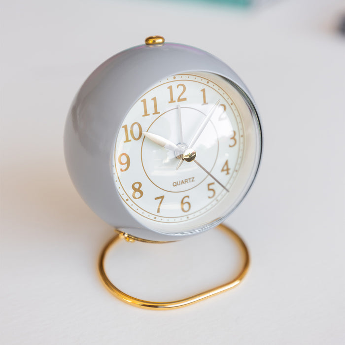 A light purple and gold alarm clock