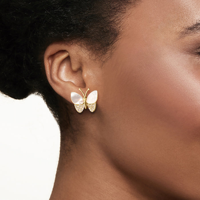 Butterfly stud earrings worn on ear, mother-of-pearl wings with CZ sparkle