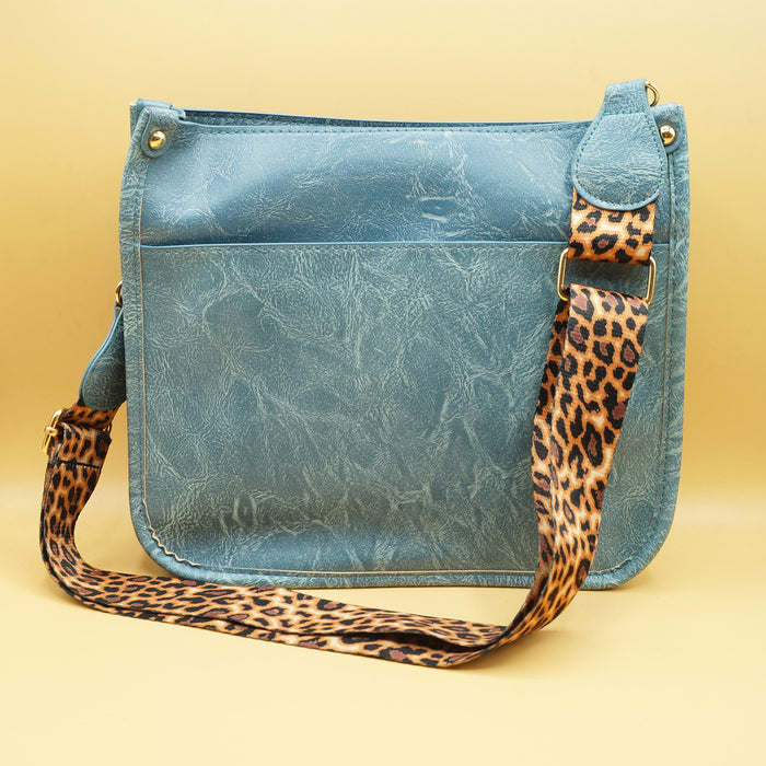 a blue faux leather bag with leopard print strap