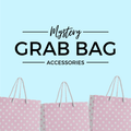 Mystery Grab Bag - Accessories. There are pink polkadot shopping bags along the bottom of the image.