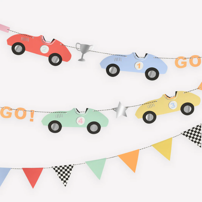 A vintage-inspired paper garland featuring classic race cars in red, blue, and yellow with shiny silver foil details, and a section with triangle flag pennants in various colors.