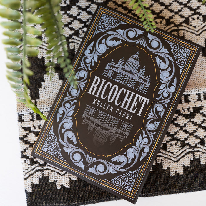 An exclusive edition of 'Ricochet' by Kellyn Carni on a textured surface with plants.