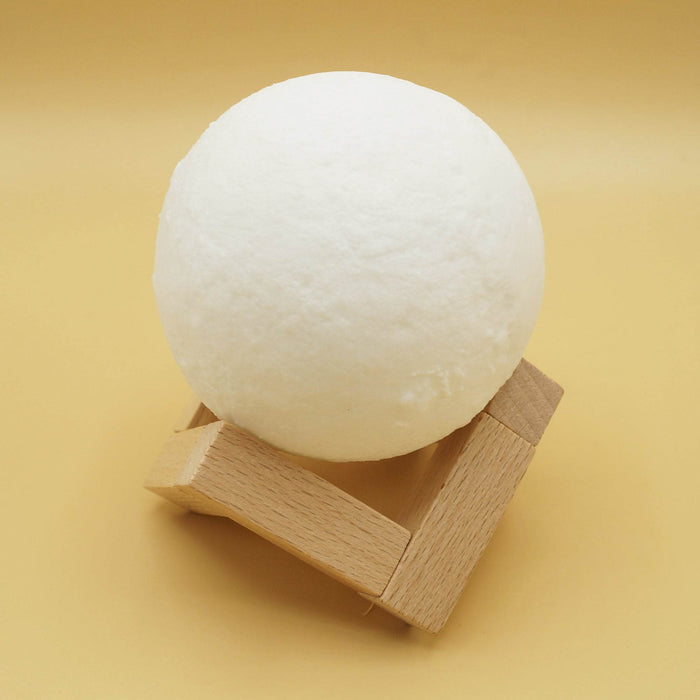 a white-colored moon light on a wooden stand