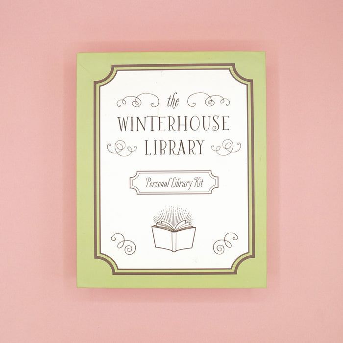 The Winterhouse Library Personal Library Kit custom box on a pink background