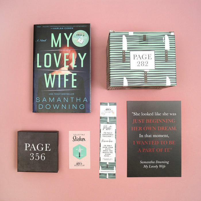 A paperback copy of 'My Lovely Wife' by Samantha Downing with stenciled page edges, two wrapped gifts labeled with page numbers, a quote print, bookmark, and collectible sticker.