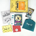 A yellow Once Upon a Book Club box is at the top of the image. In front of the box are a coloring page, book-shaped sticker, bookmark, yellow box, hardcover edition of Winston Chu vs the Whimsies, red envelope, teal drawstring bag, and book flyer. The boxes and bags all have page numbers.