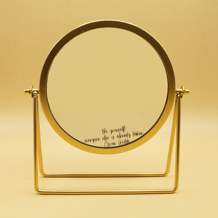 a vanity mirror with gold trim. On the bottom of the mirror is the quote "Be Yourself, everyone else is already taken" - Oscar Wilde