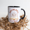 A white mug with a black handle and black inside, with the quote What the Actual Plot Twist? on the side with an image of a skeleton reading a book.