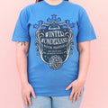 Person wearing a blue t-shirt with 'Winter Wonderland Book Festival' design on a pink background