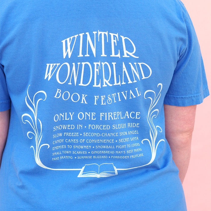 Blue t-shirt with white text and design on a person wearing it.