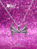 A Winx Club Tecna Enchantix Fairy Wings Necklace, featuring brass material and cubic zirconia, displayed on a chain against a pink glittery background.